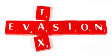 TAX EVASION spelt out in red lettered tiles.