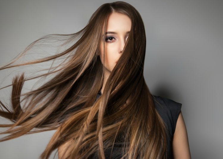 Portrait of calm emotionless model with long windy hair.Studio shot.