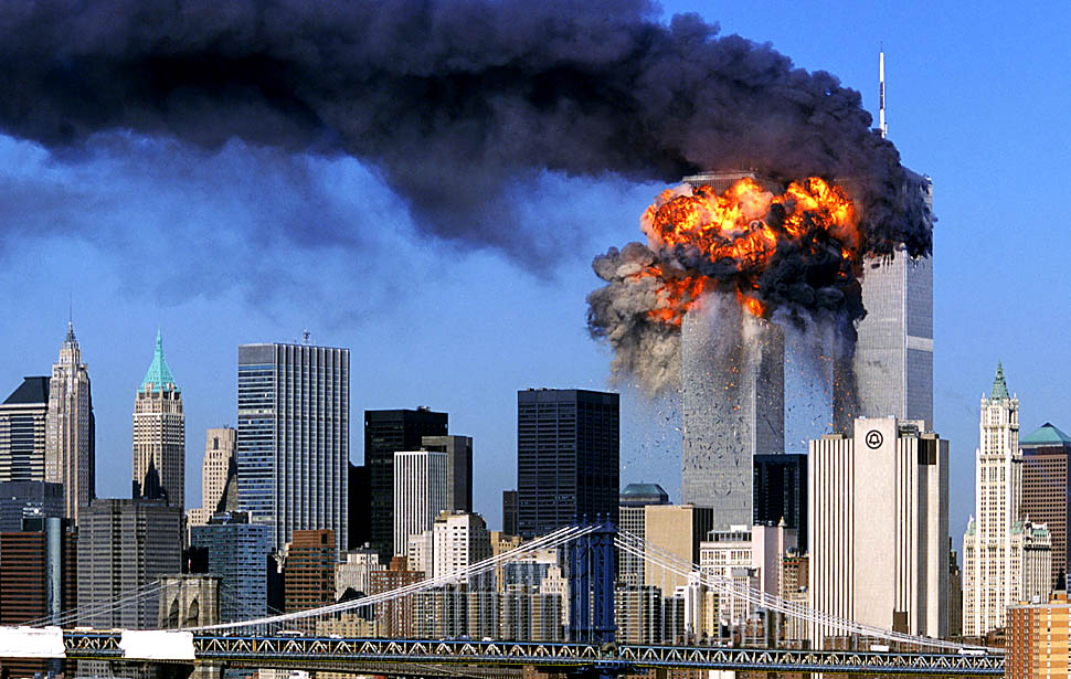 SEVENTH IN A PACKAGE OF NINE PHOTOS.-- An explosion rips through the  South Tower of the World Trade Towers after the hijacked United Airlines Flight 175, which departed from Boston en route for Los Angeles, crashed into it Sept, 11, 2001. The North Tower is shown burning after American Airlines Flight 11 crashed into the tower at 8:45 a.m.